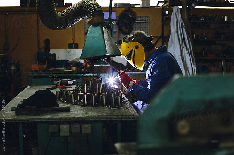 locksmith welding aluminium in his workshop