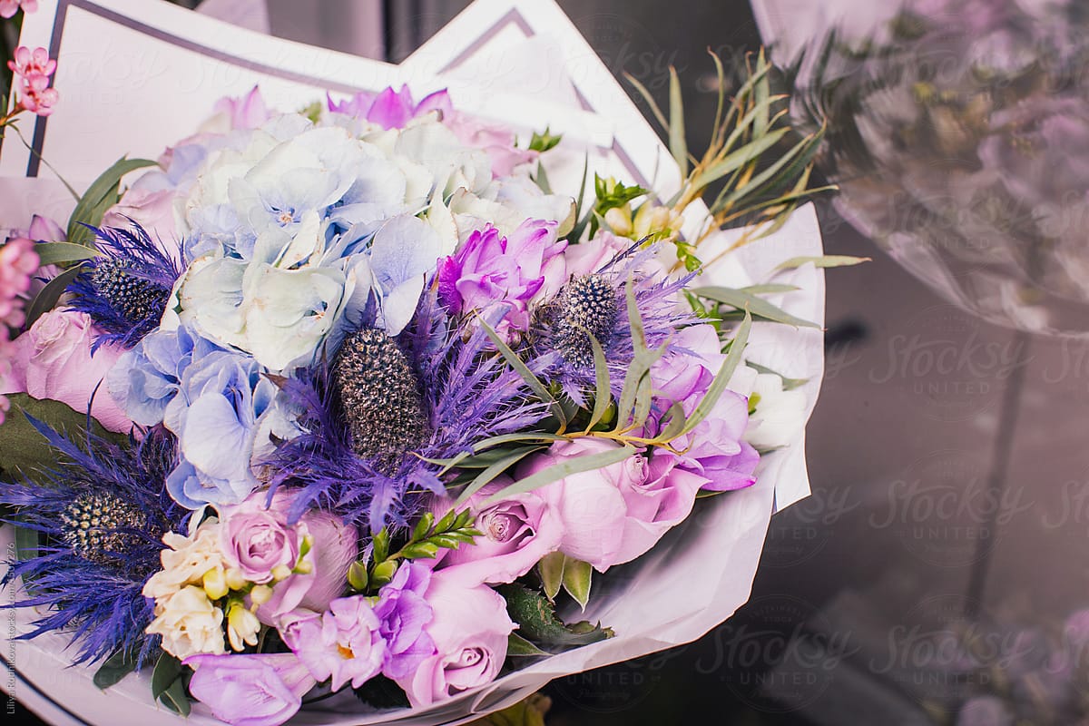 Arranged bouquet of violet flowers in package