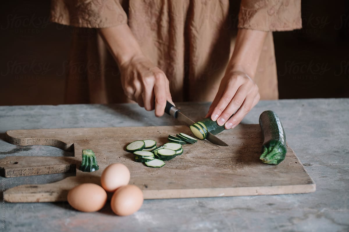 Woman slising small zucchini