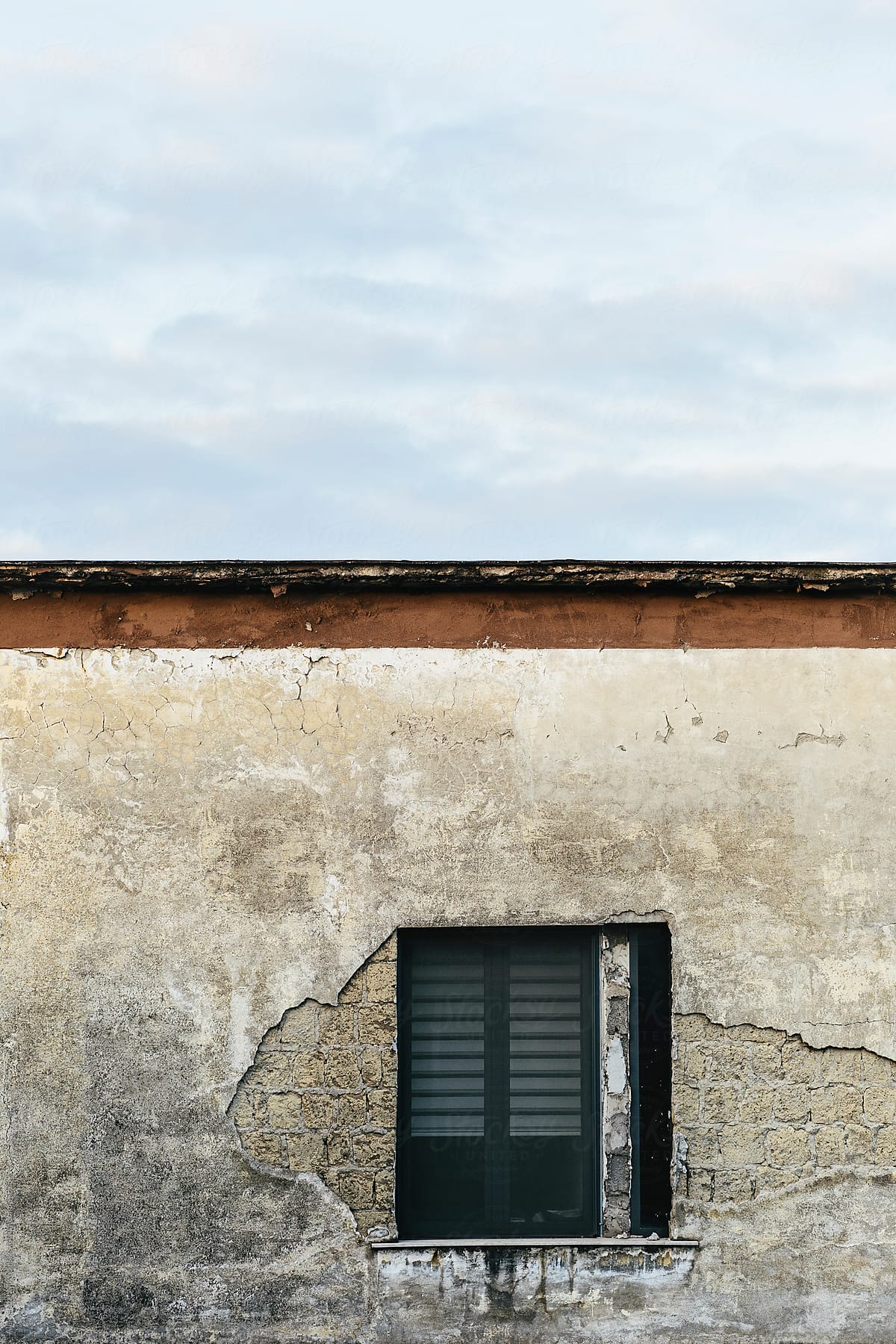 Minimalistic shot of old building with window in Italy