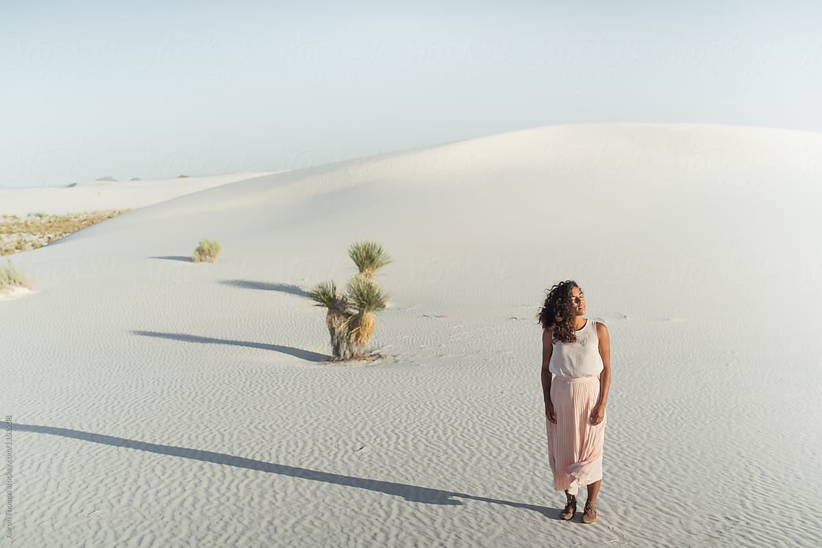 Girl standing in desert alone