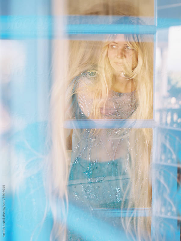 double exposure of blonde girl portrait in window