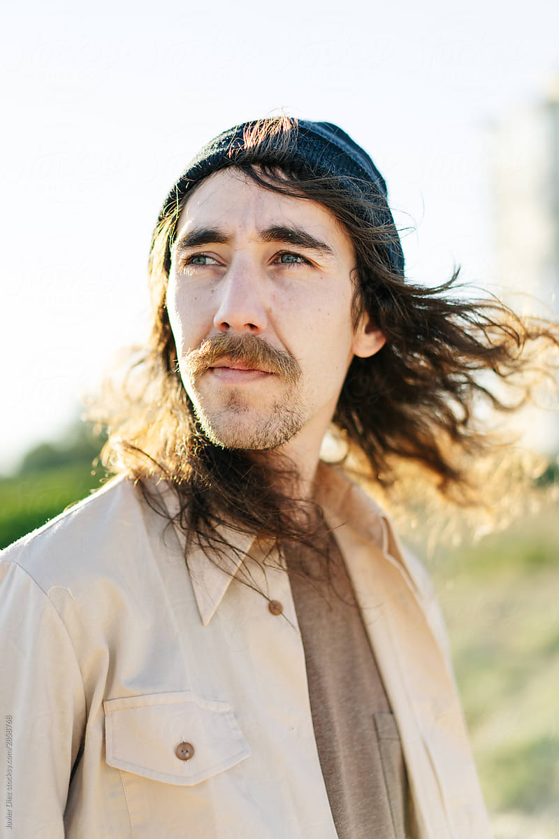 Man with long hair in field