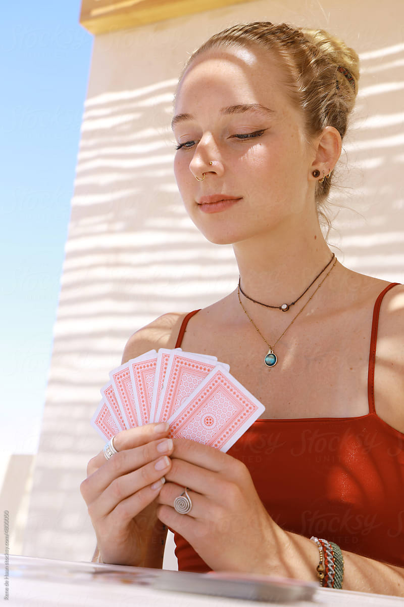 young woman playing card game