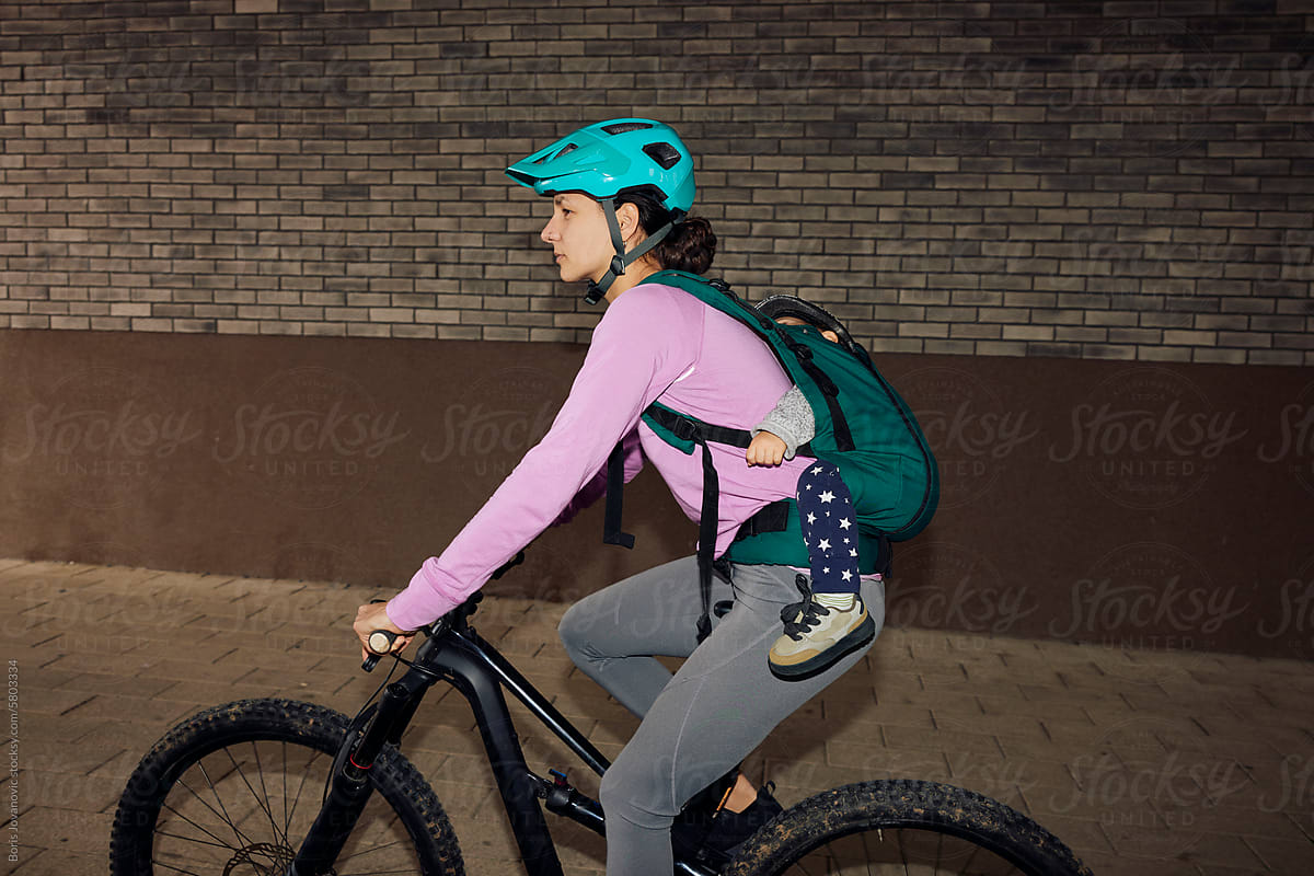 Portrait of a sportswoman cycling with her child