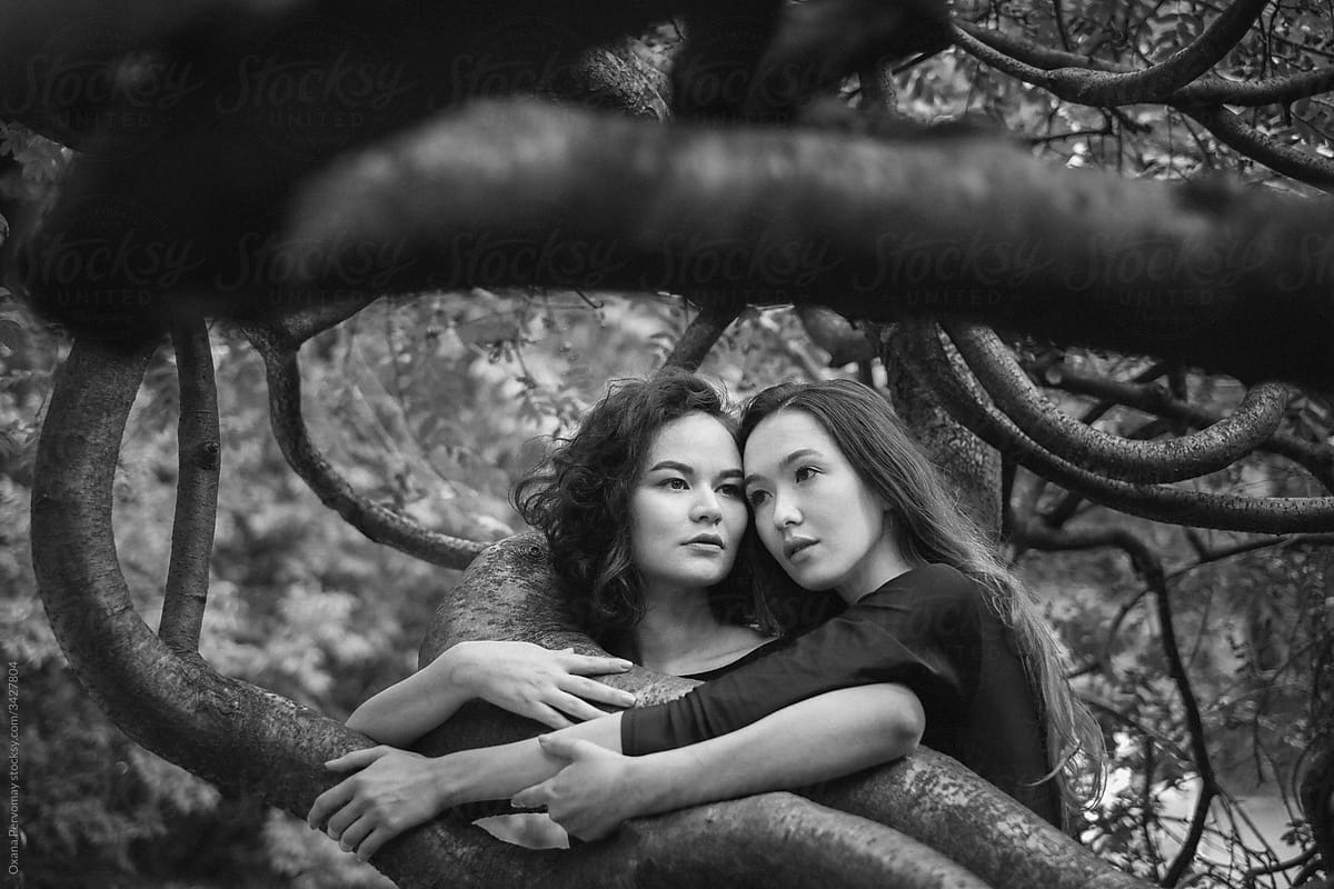 Two girls in the branches.