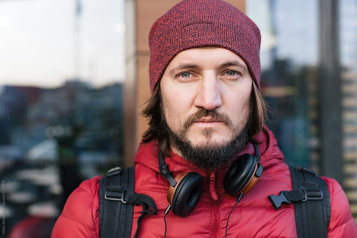 Closeup portrait of handsome man with earphones outdoor