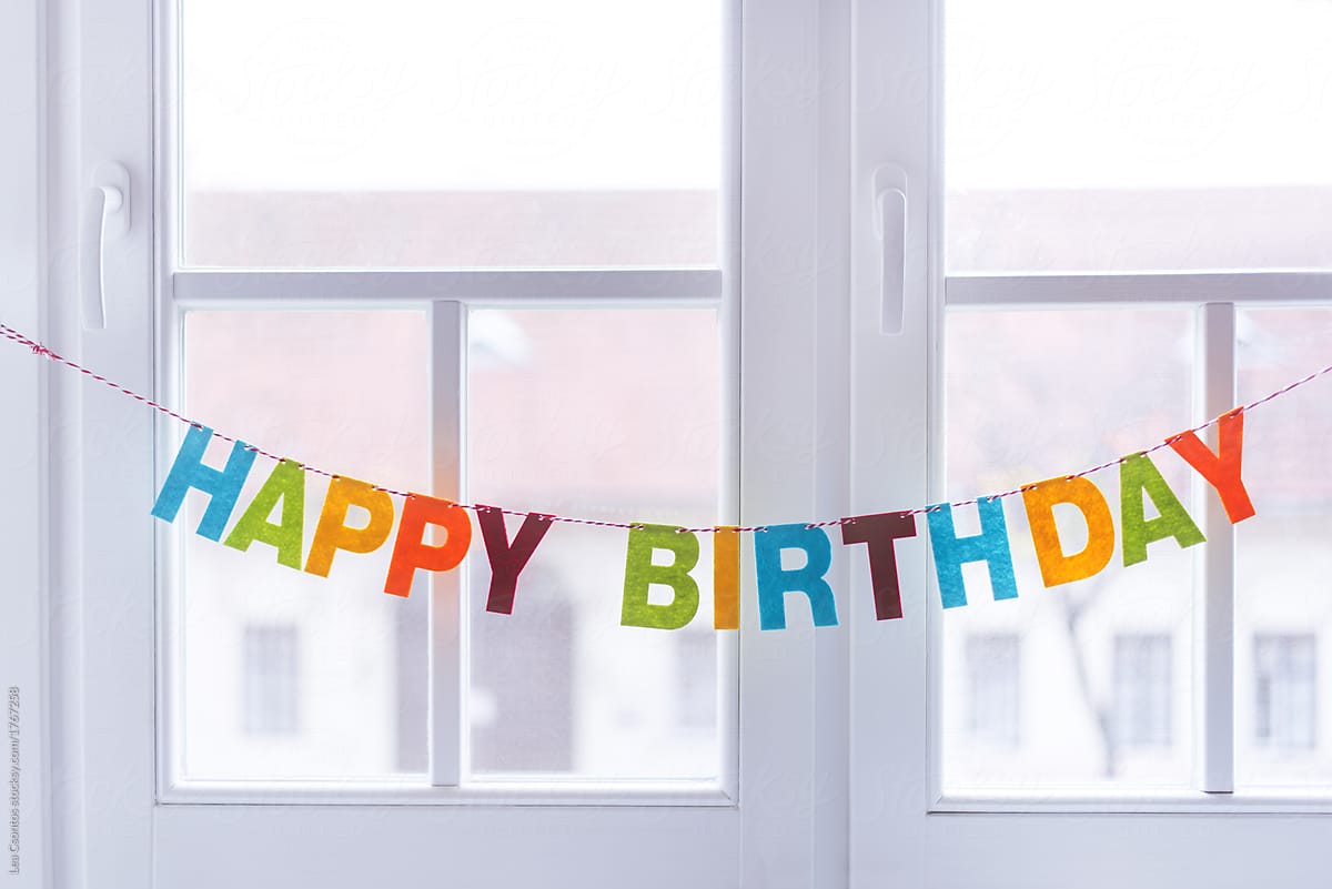 Happy Birthday garland hanging on a window