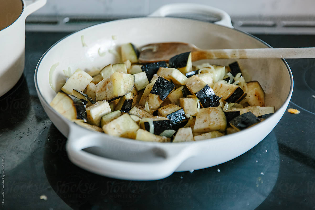 Diced aubergine being sauteed in a home kitchen
