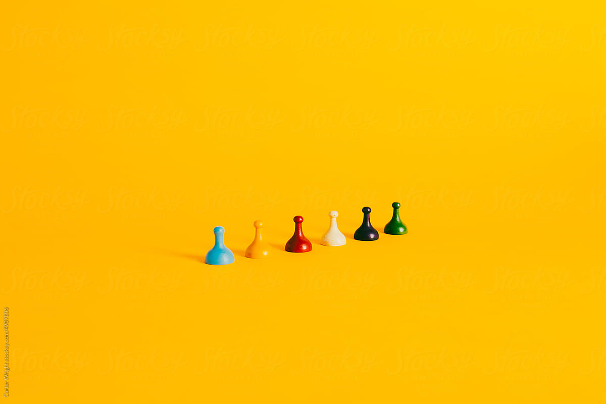 Colorful Board Game pieces on a vibrant yellow background
