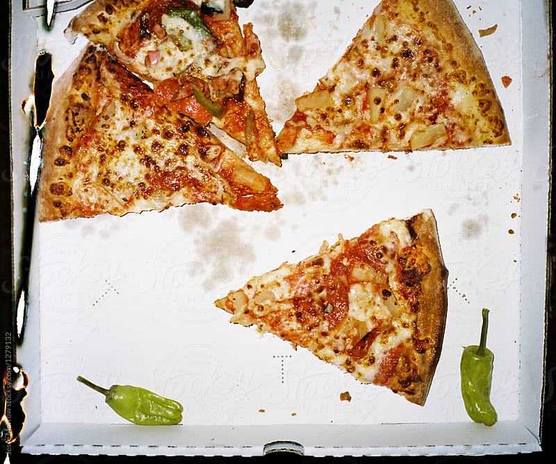 Pizza slices in box with peppers