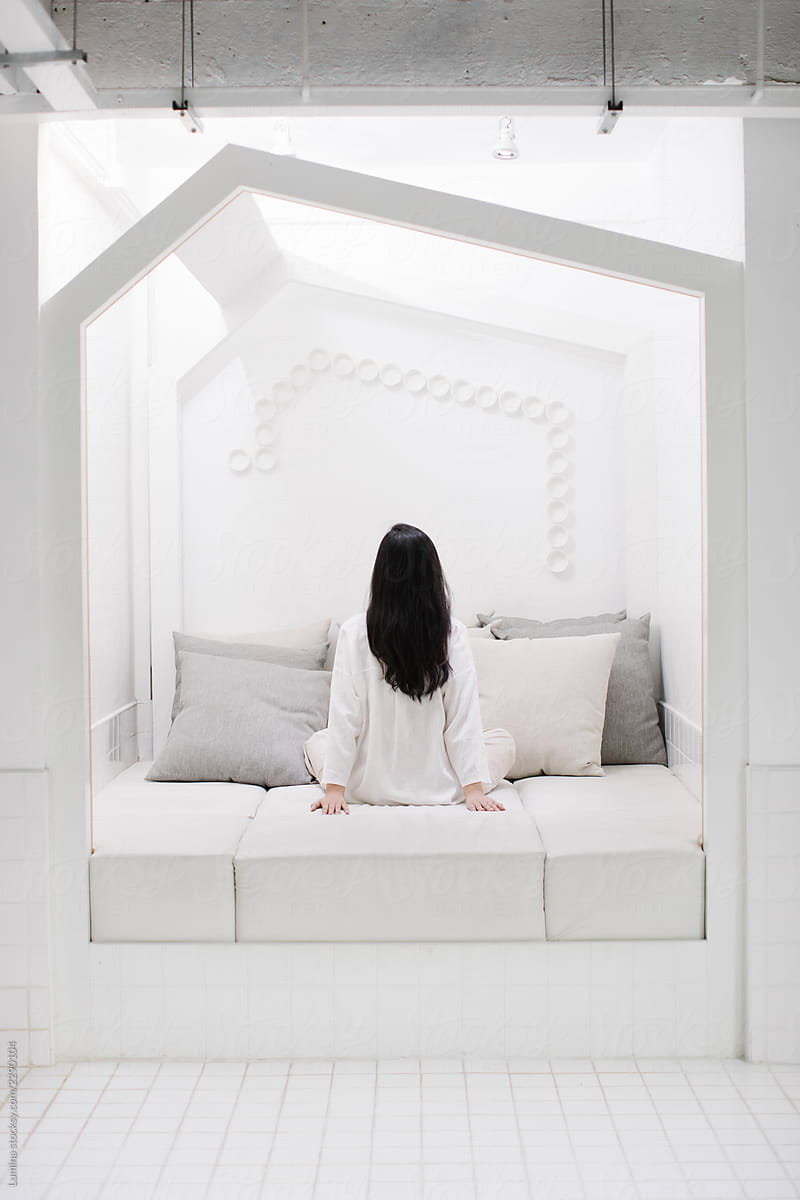 Woman Sitting in White  Neat Space