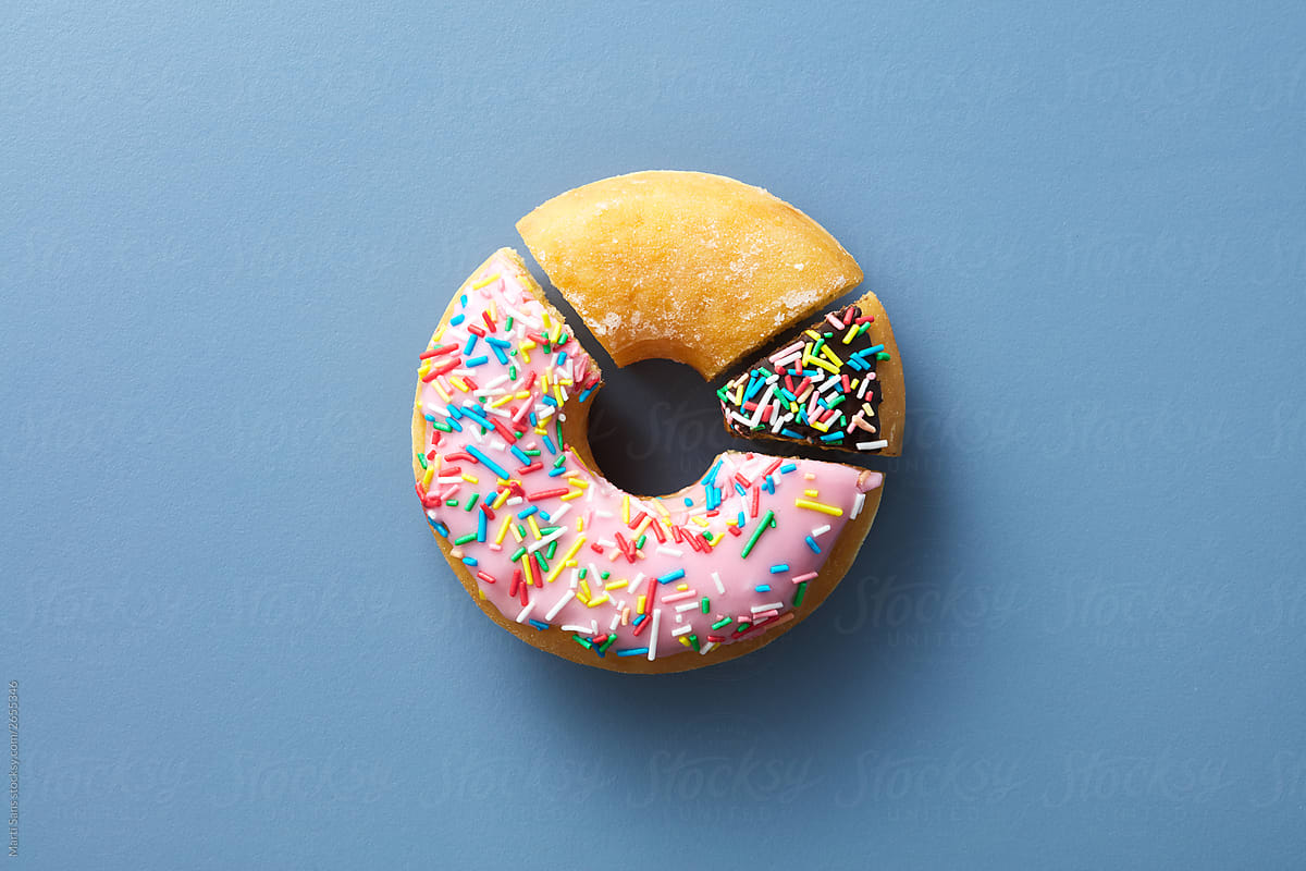 Colorful pie chart made of donut pieces with various glaze