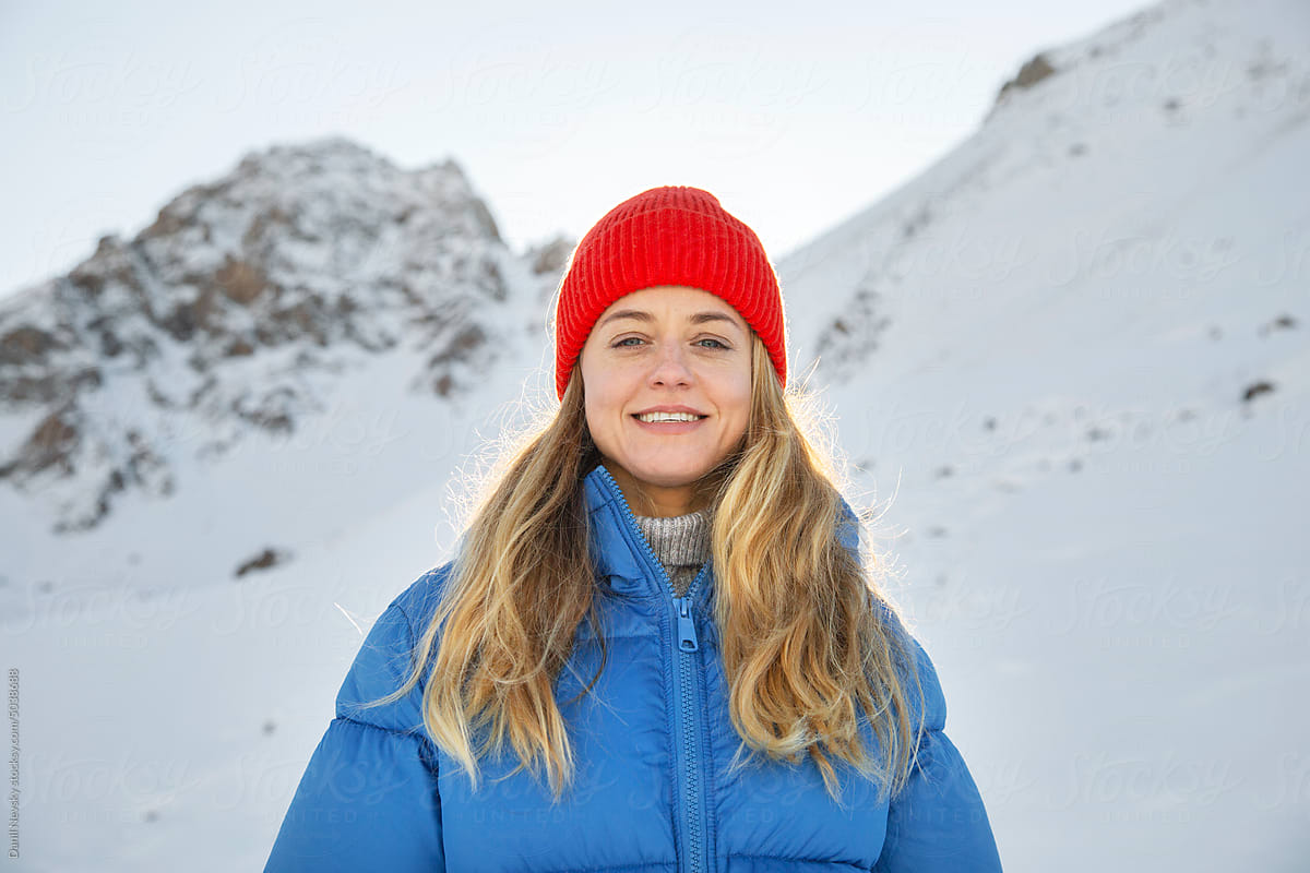 Cheerful woman against snowy mountains