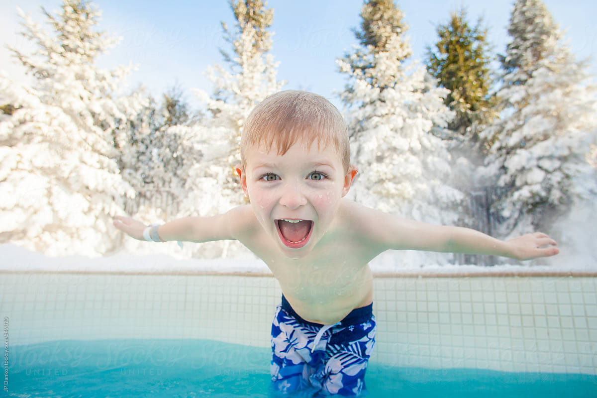 Happy Boy At Snowy Outdoor Hot Tub at Winter Ski Resort
