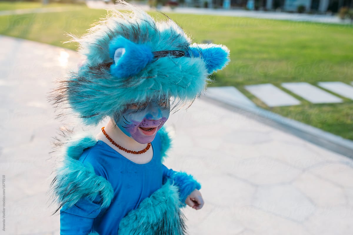Close up of a little boy in bright blue cat costume