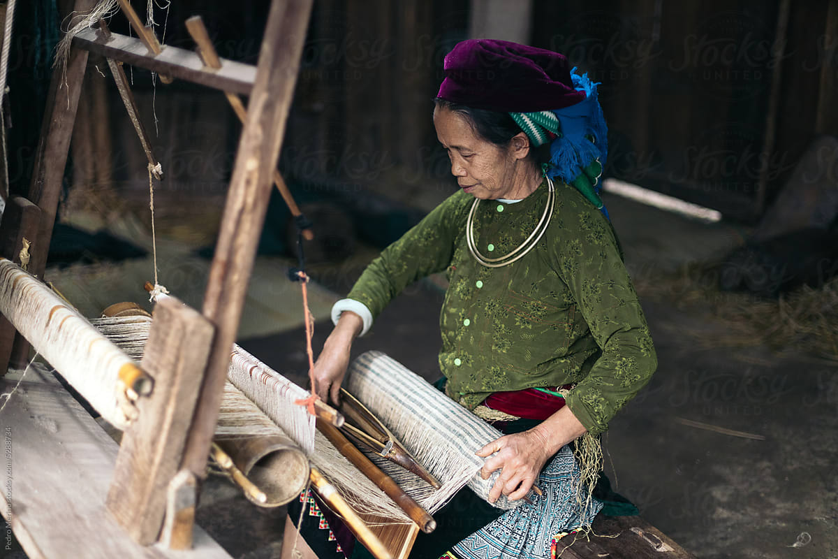 Traditional production: local weaver working with a loom in a workshop