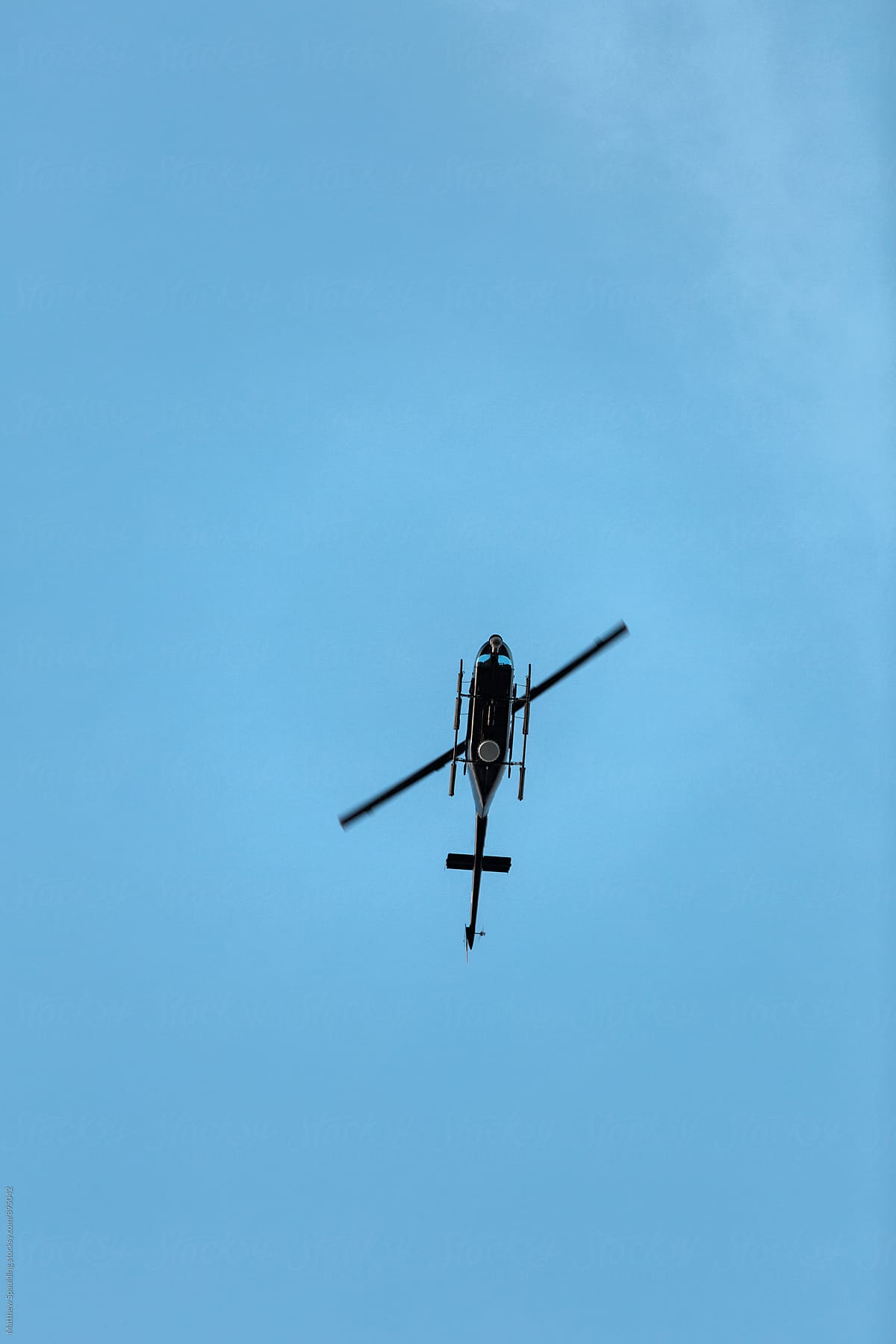 Helicopter hovering above in sky