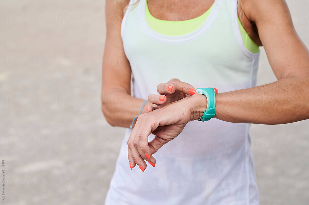 Woman setting her watch before a run