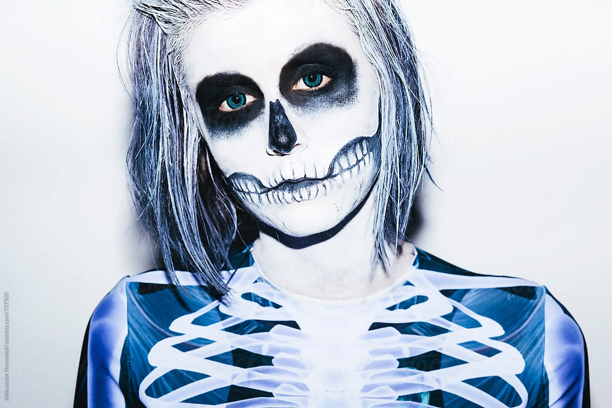 Portrait of a young woman with halloween make up and skeleton costume