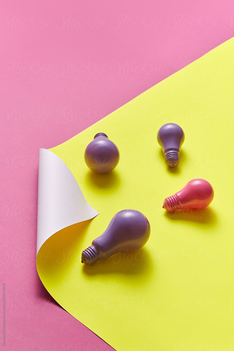 Colored light bulbs on bright background