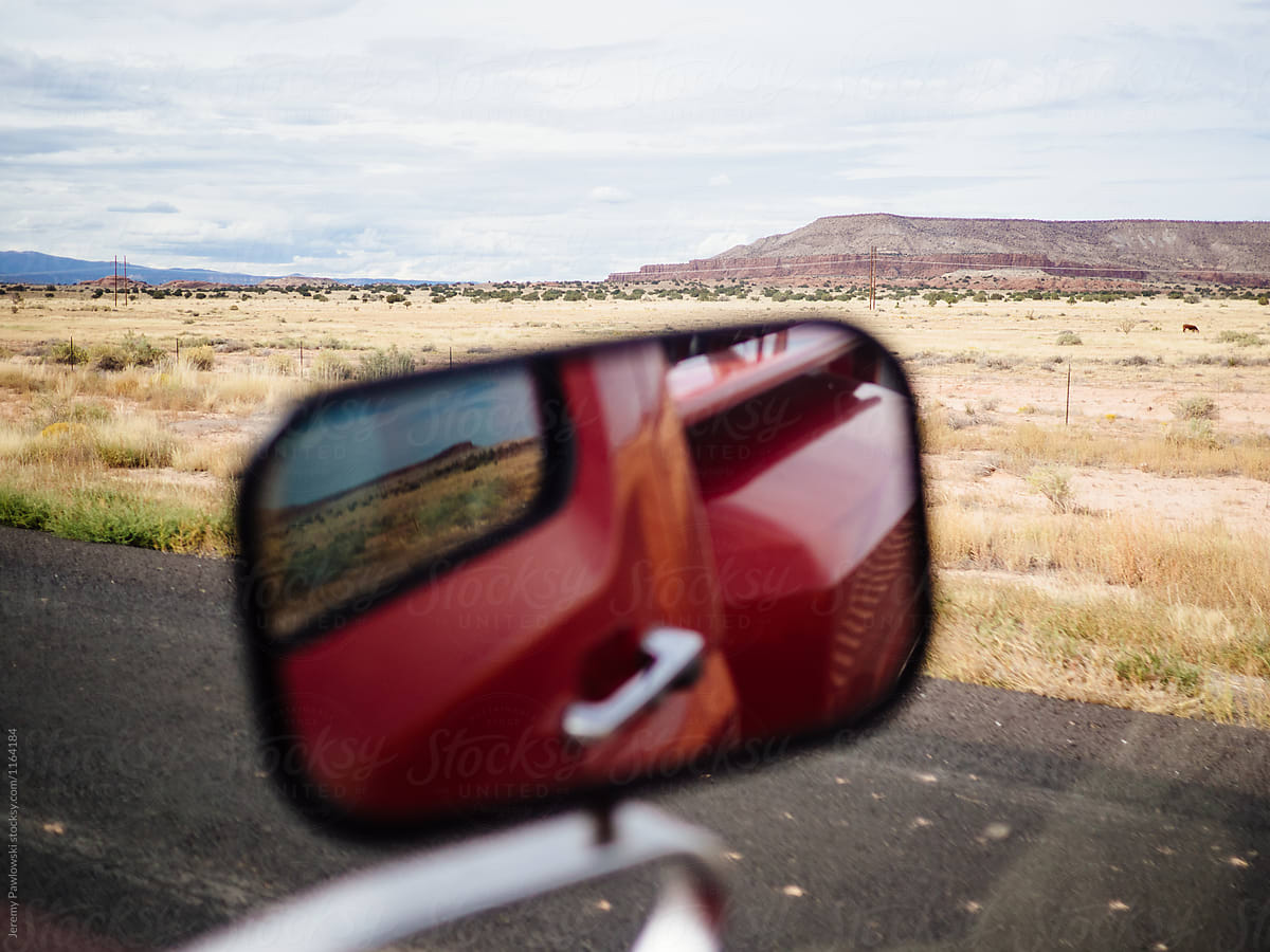 Reflection of red truck and handle in mirror