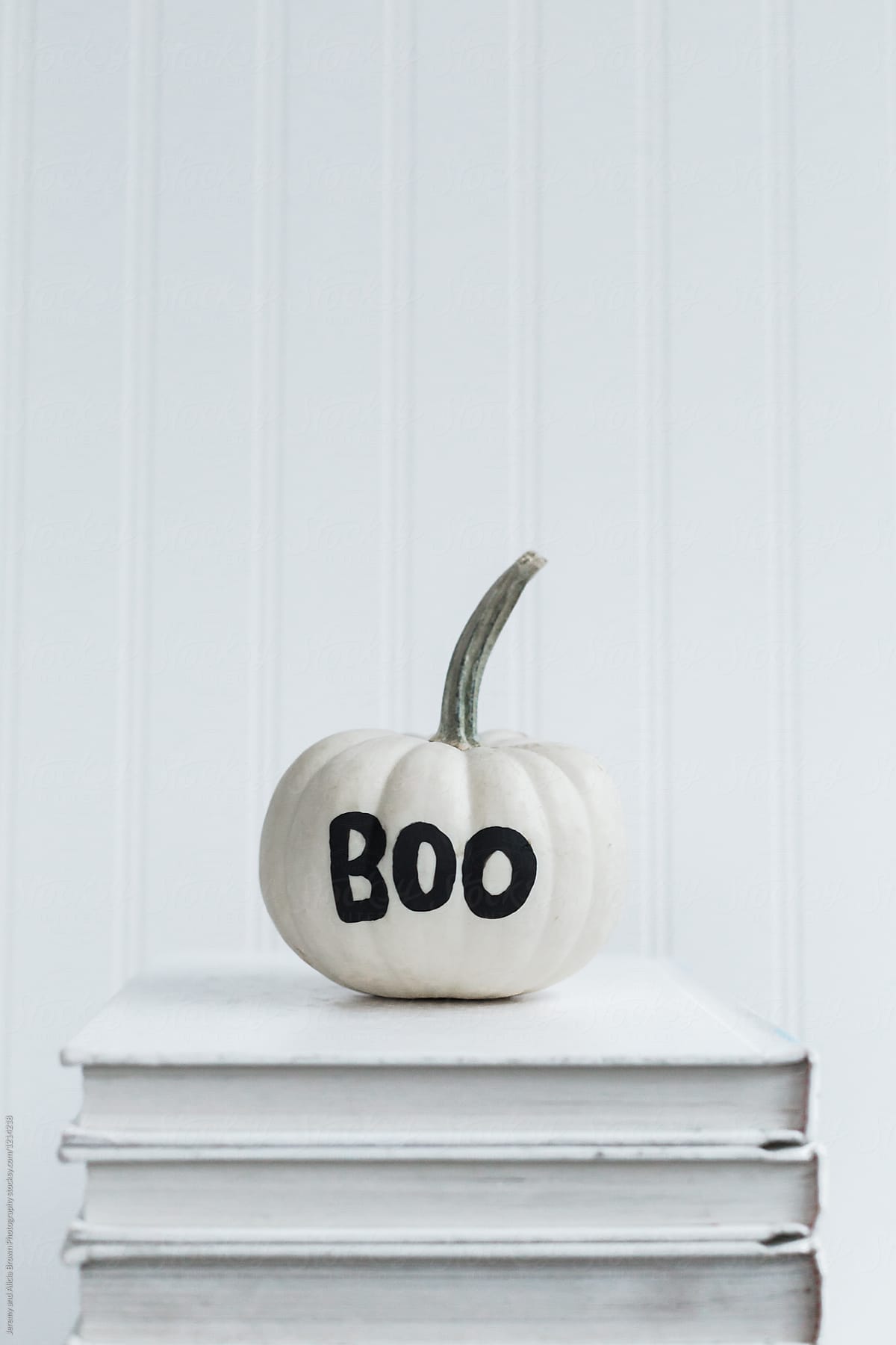 Boo painted on a white pumpkin