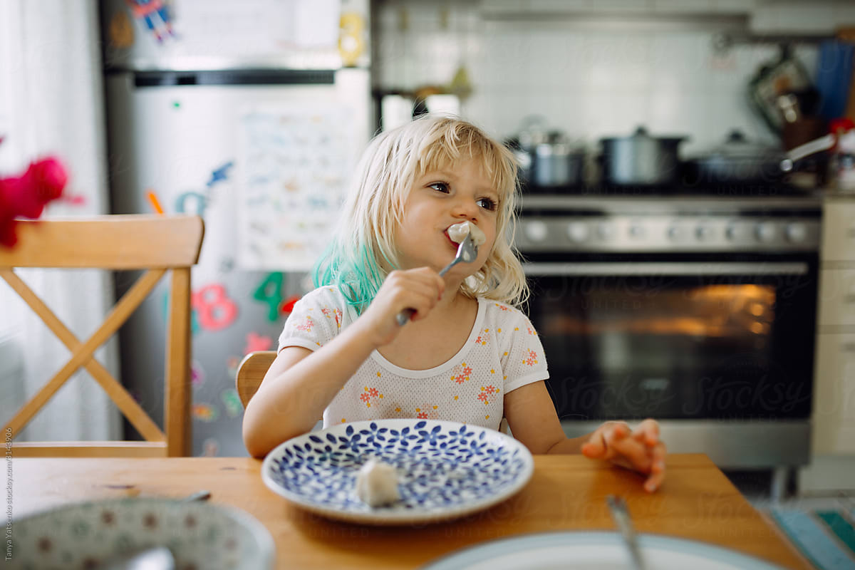 Girl eating in the kitchen