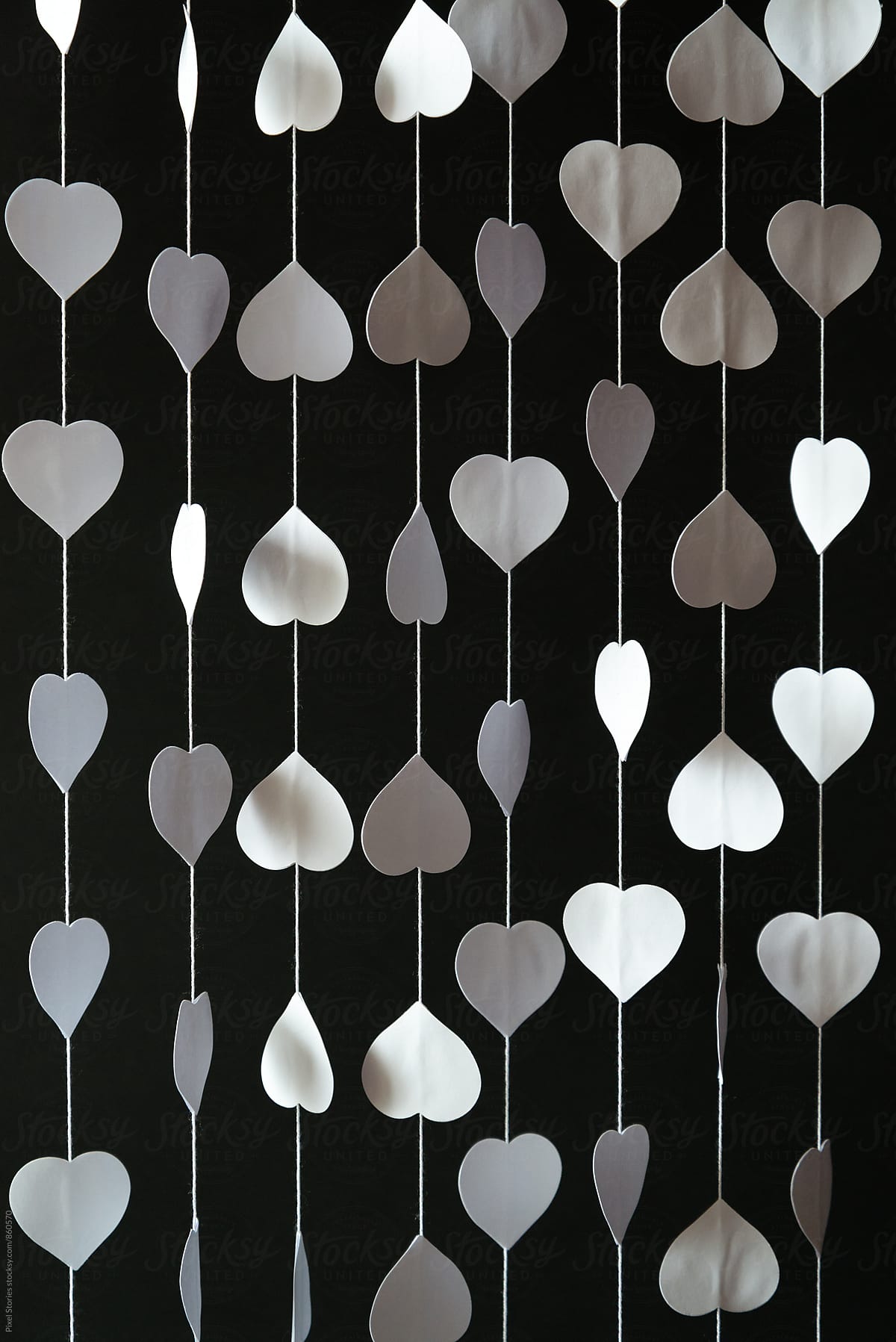 Diy white hearts curtain over black background