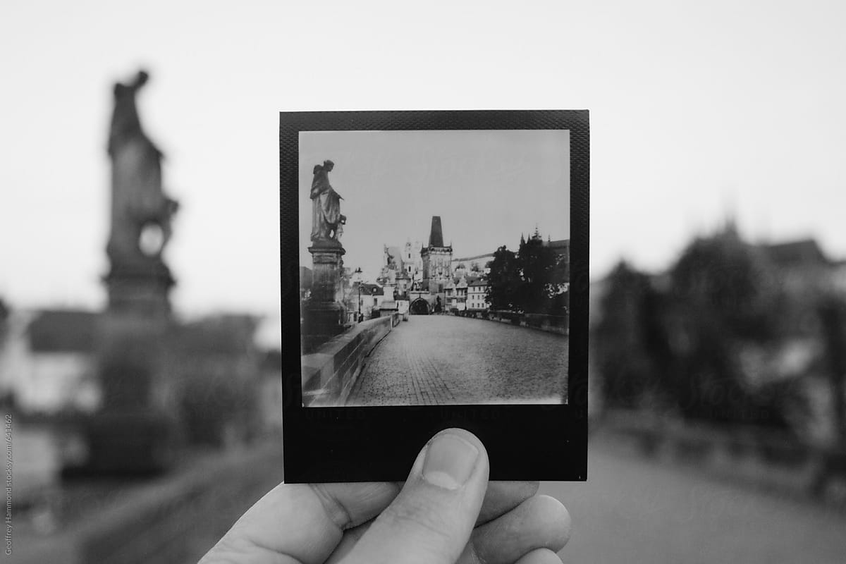 Holding a Polaroid Print up on Charles Bridge, Prague