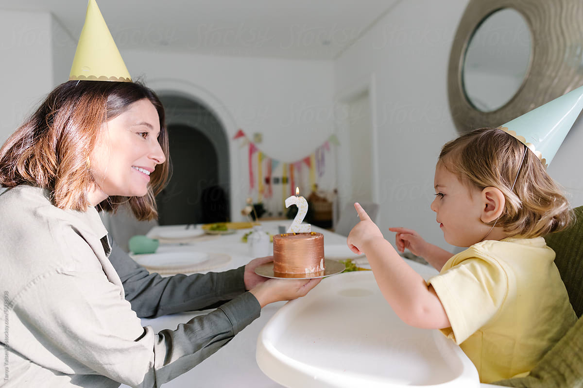 A boy celebrates his birthday with his mother