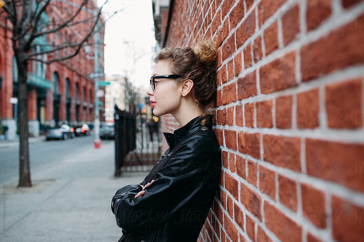 Profile Of A Beautiful Woman Leaning Against A Brick Wall In Nyc By ...