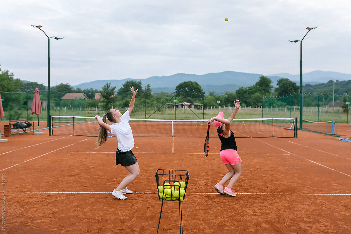 Young students practicing tennis on the court