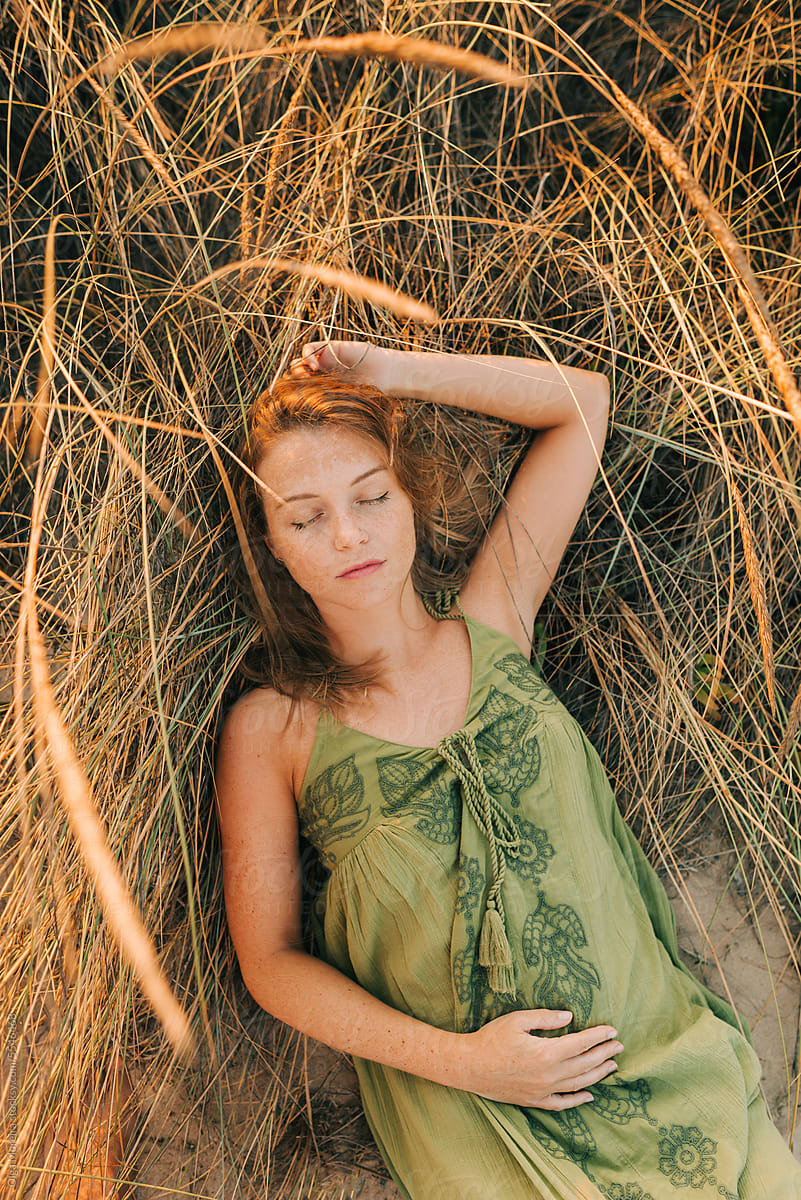 Portrait of a woman lying down in grass