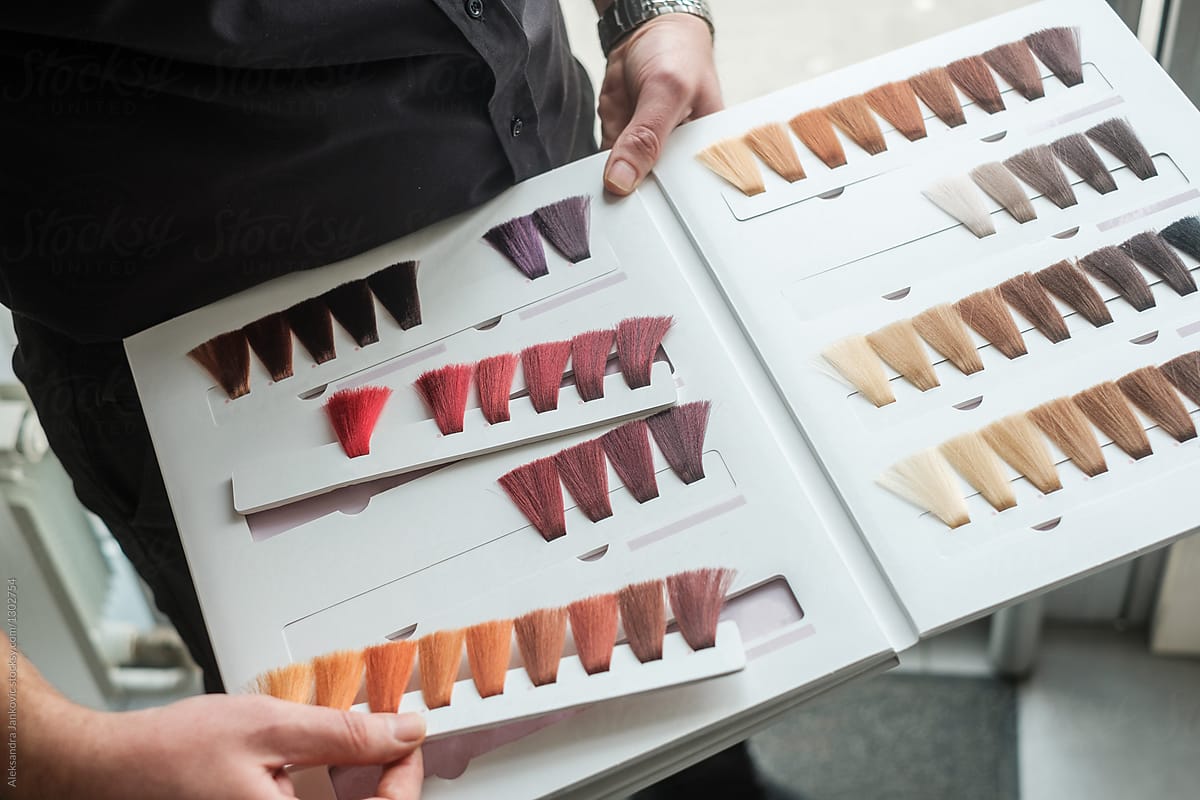 Anonymous Hairdresser Holding A Hair Color Palette Samples