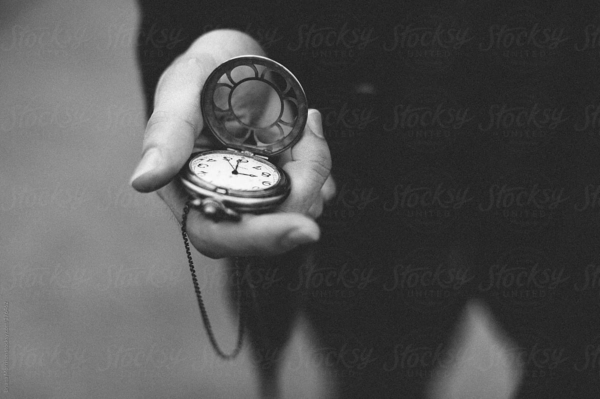 Hand Holding Pocket Watch in Black and White