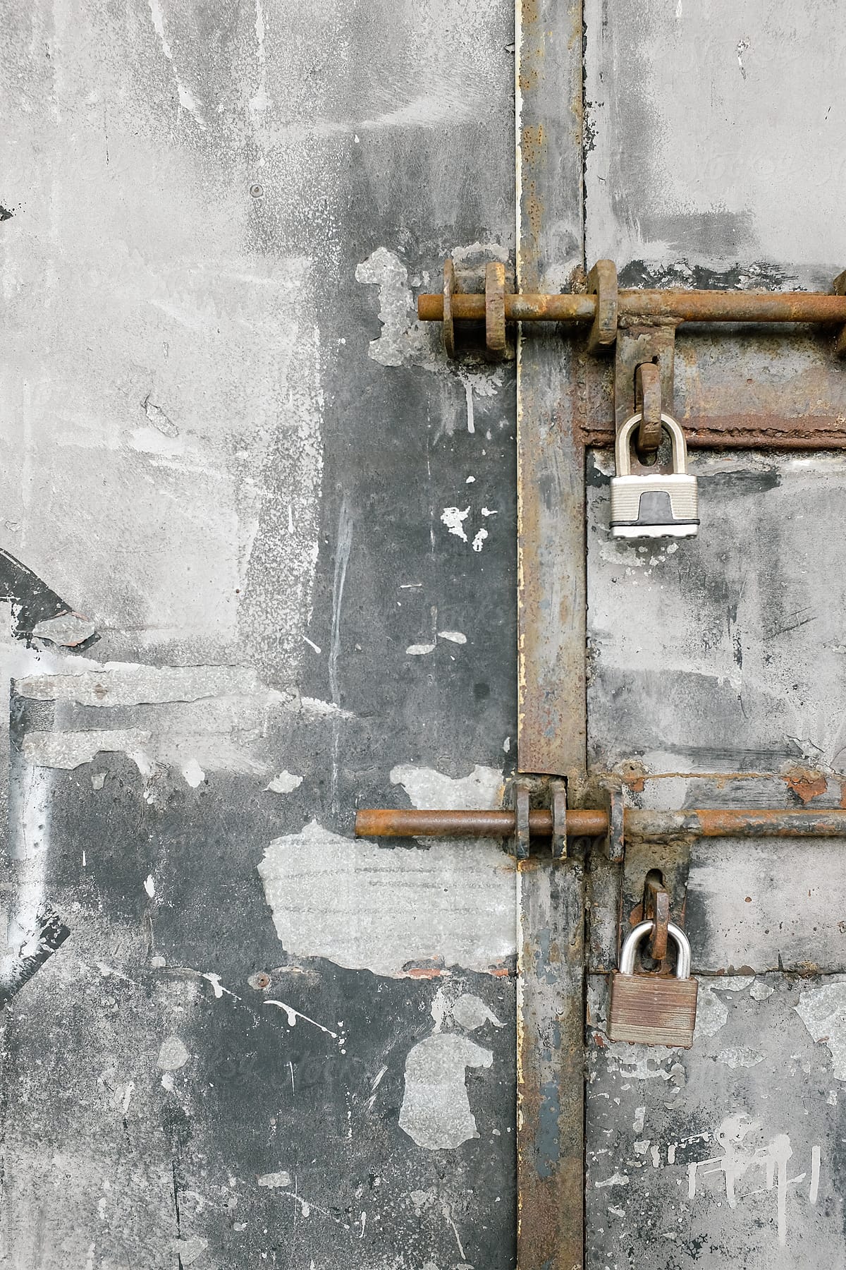 Old grungy metal door with locks and rust and eroded metal