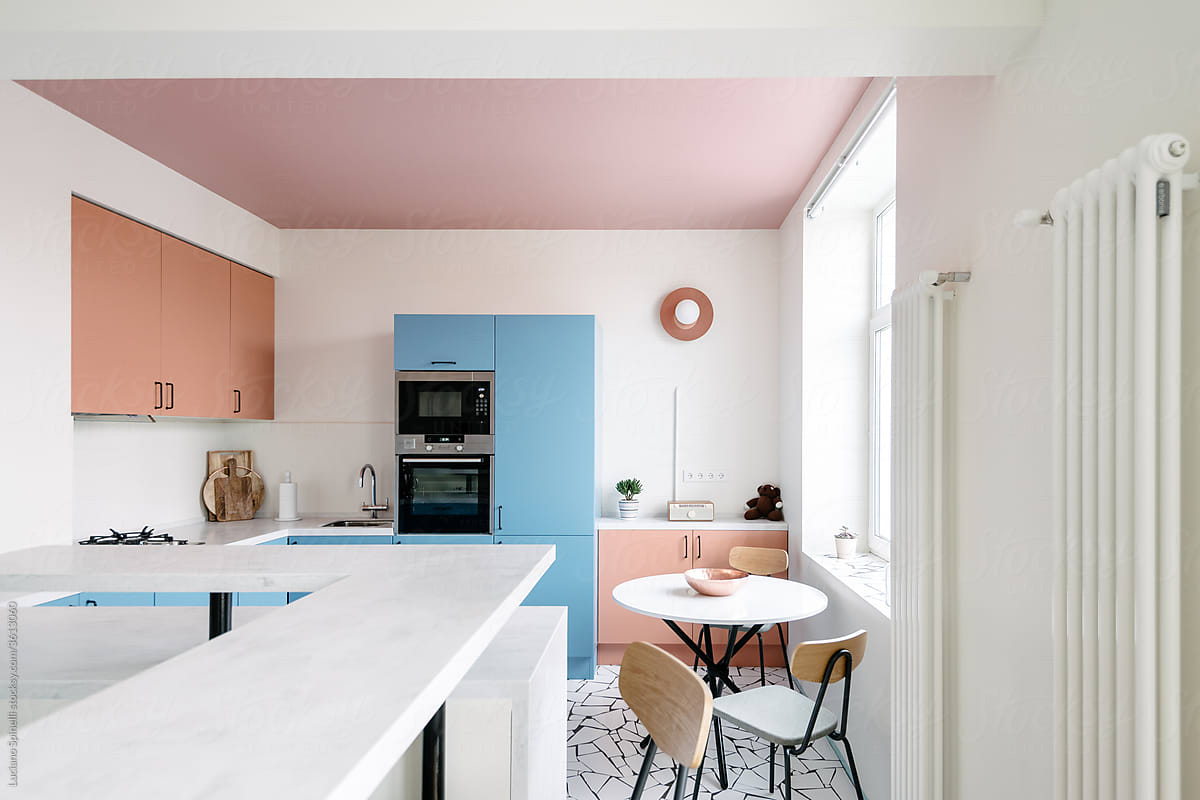 View over the table top of a colourful kitchen and living