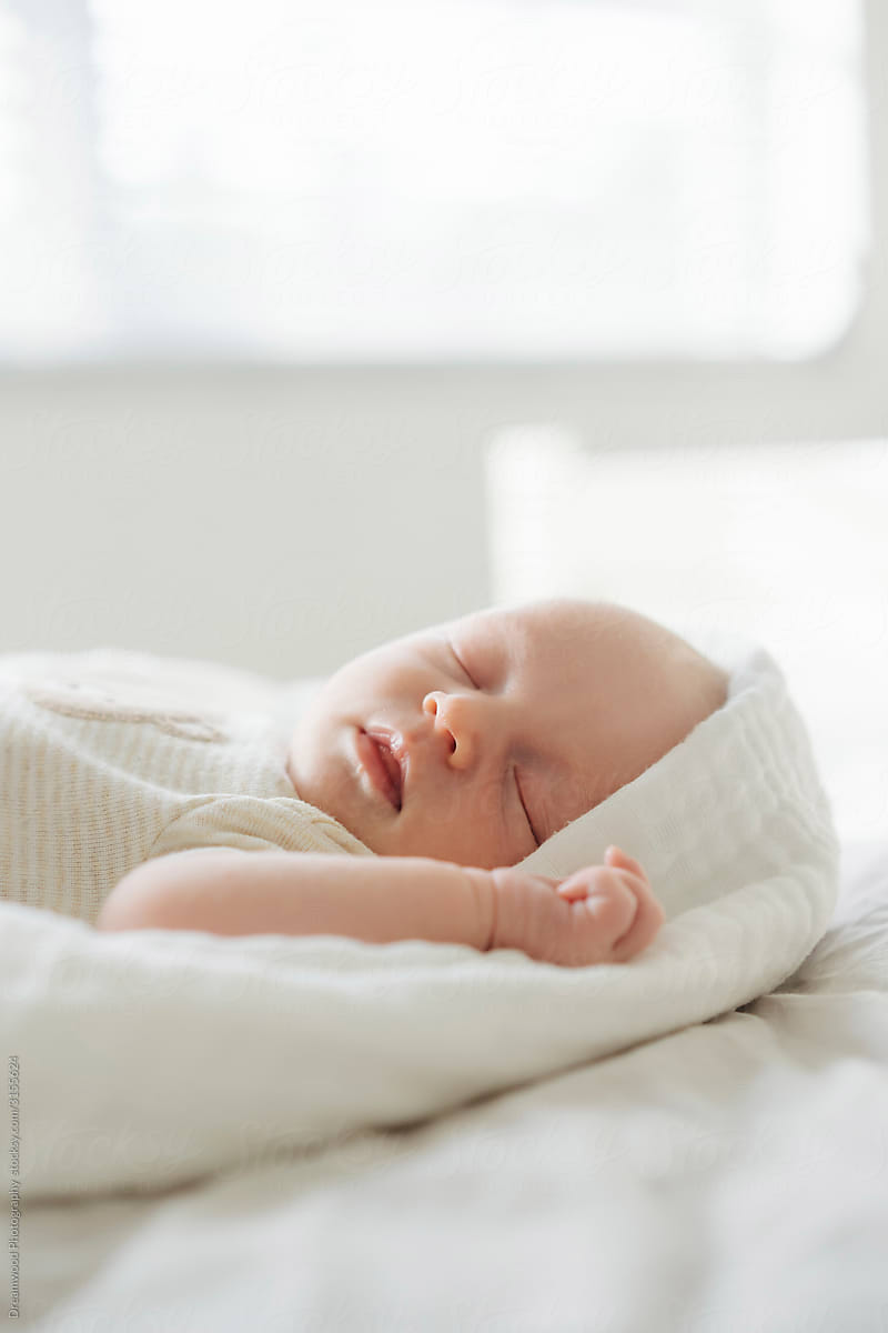 Tranquil newborn child sleeping in bedroom