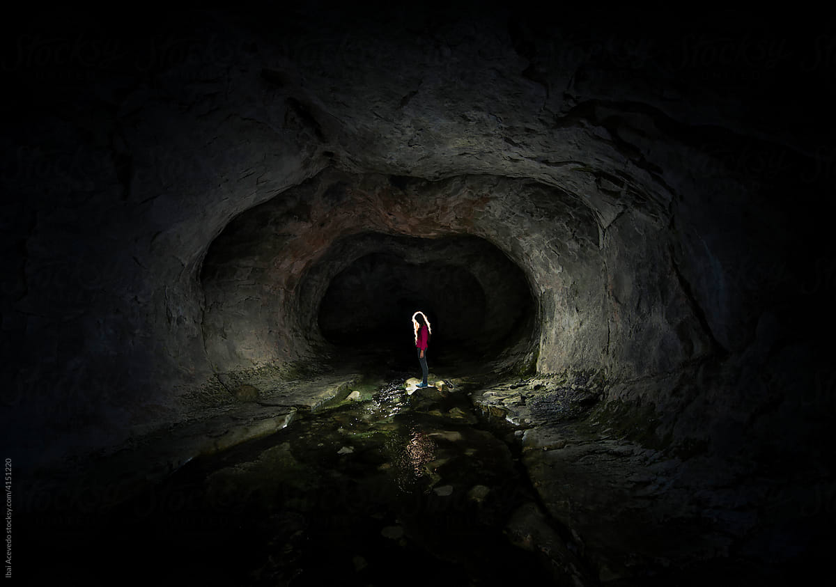 Standing woman inside a cave