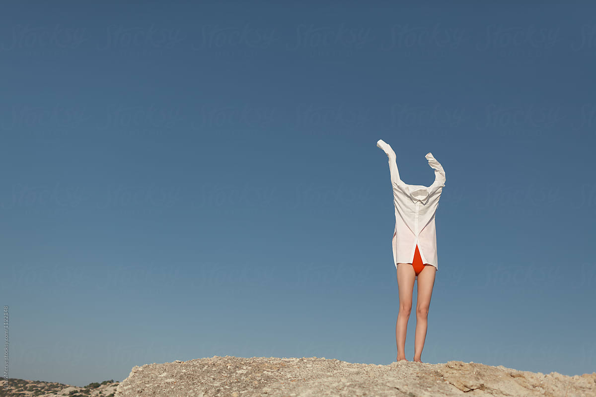 Woman Takes Off Her White Shirt By Stocksy Contributor Ulasandmerve