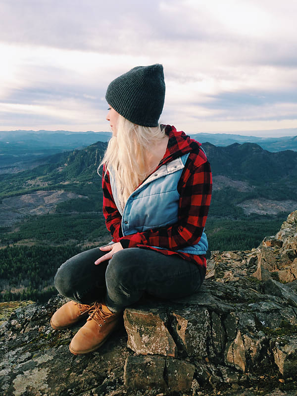 Girl sitting on mountain top by Kevin Gilgan - Stocksy United