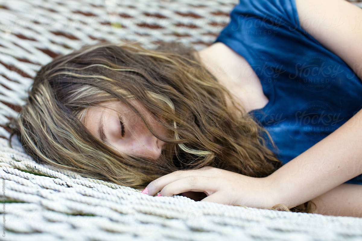 Teenage Girl Laying On The Hammock Hair Hiding Her Face By Stocksy Contributor Carolyn