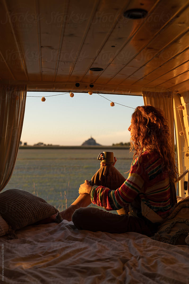 woman with coffe in camper van