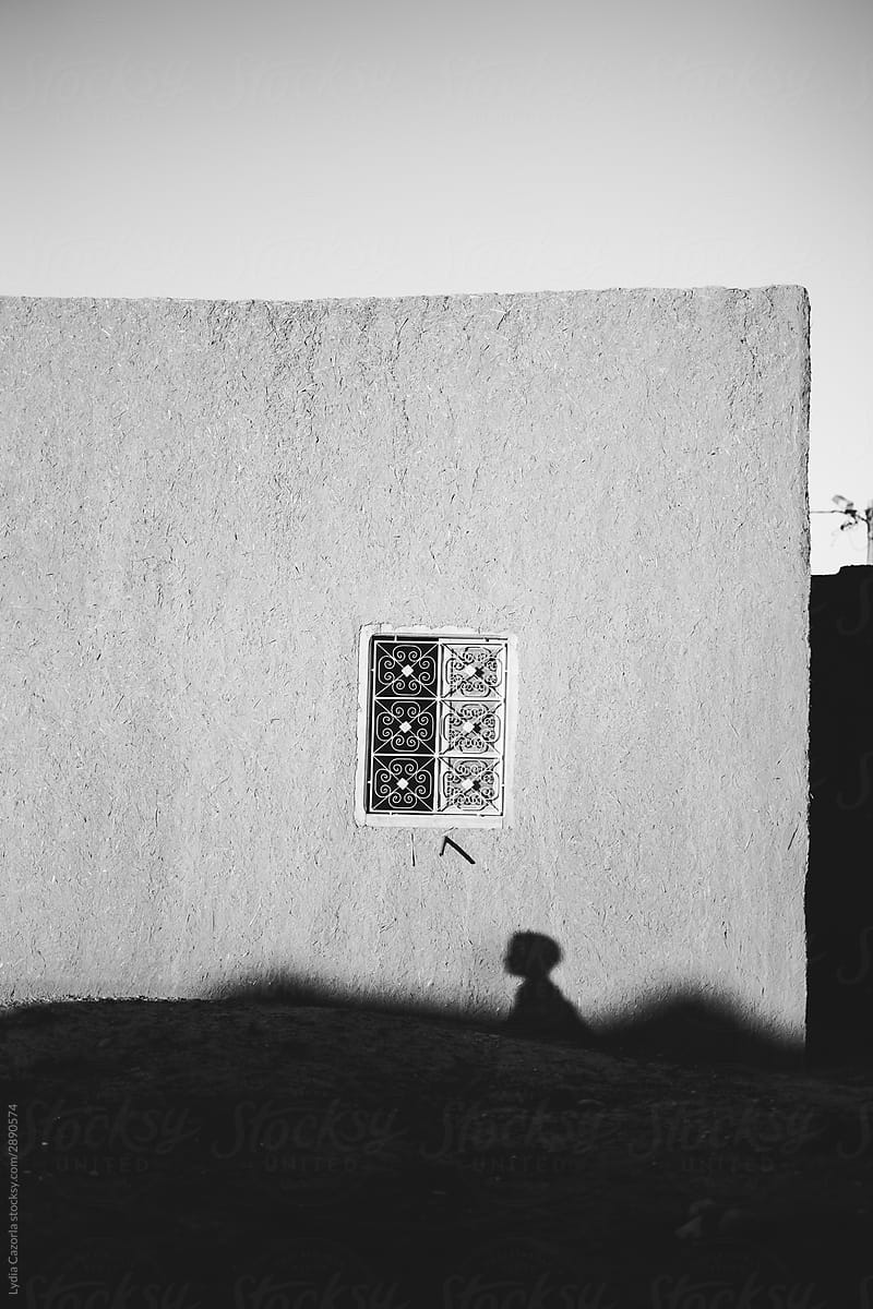 Typical house in the Sahara with a shadow of a child