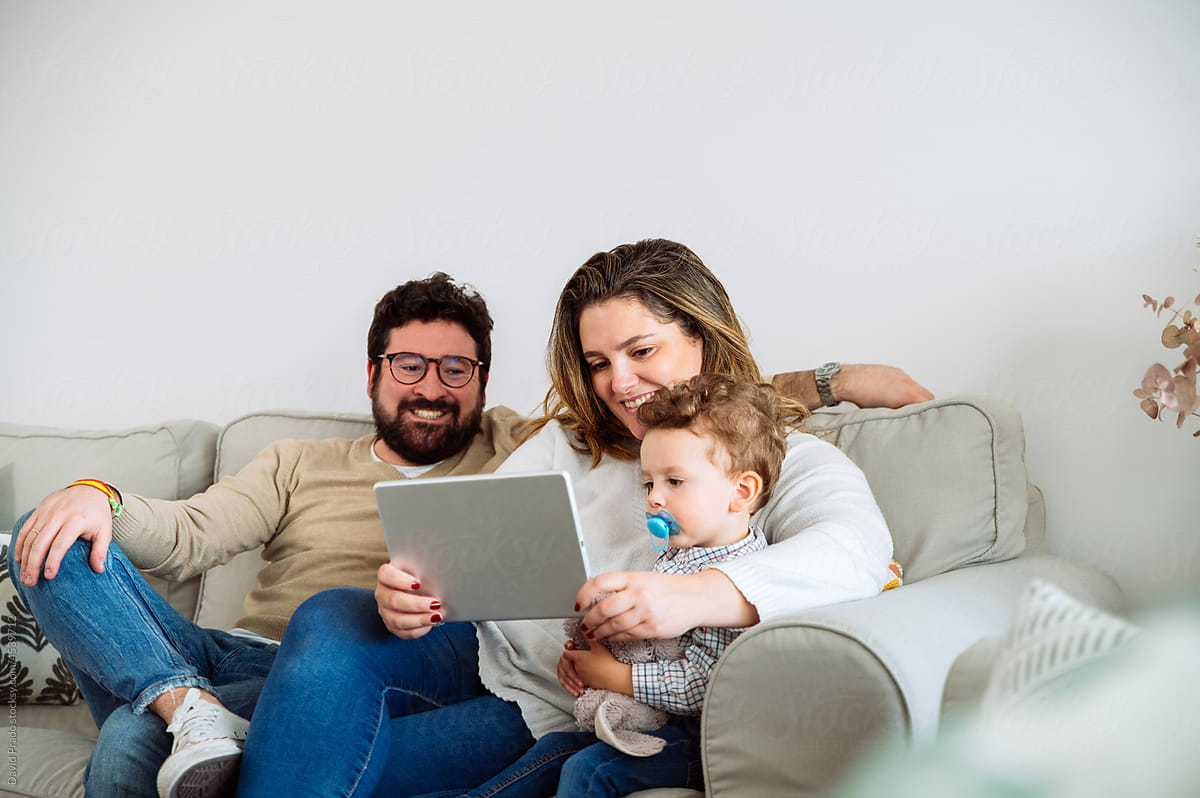 Happy family watching video on tablet together