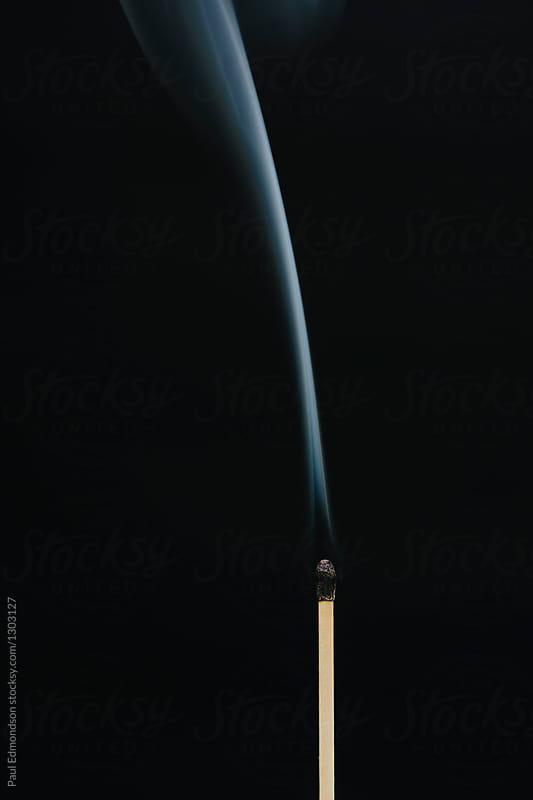 Close up of smoke rising off lit match