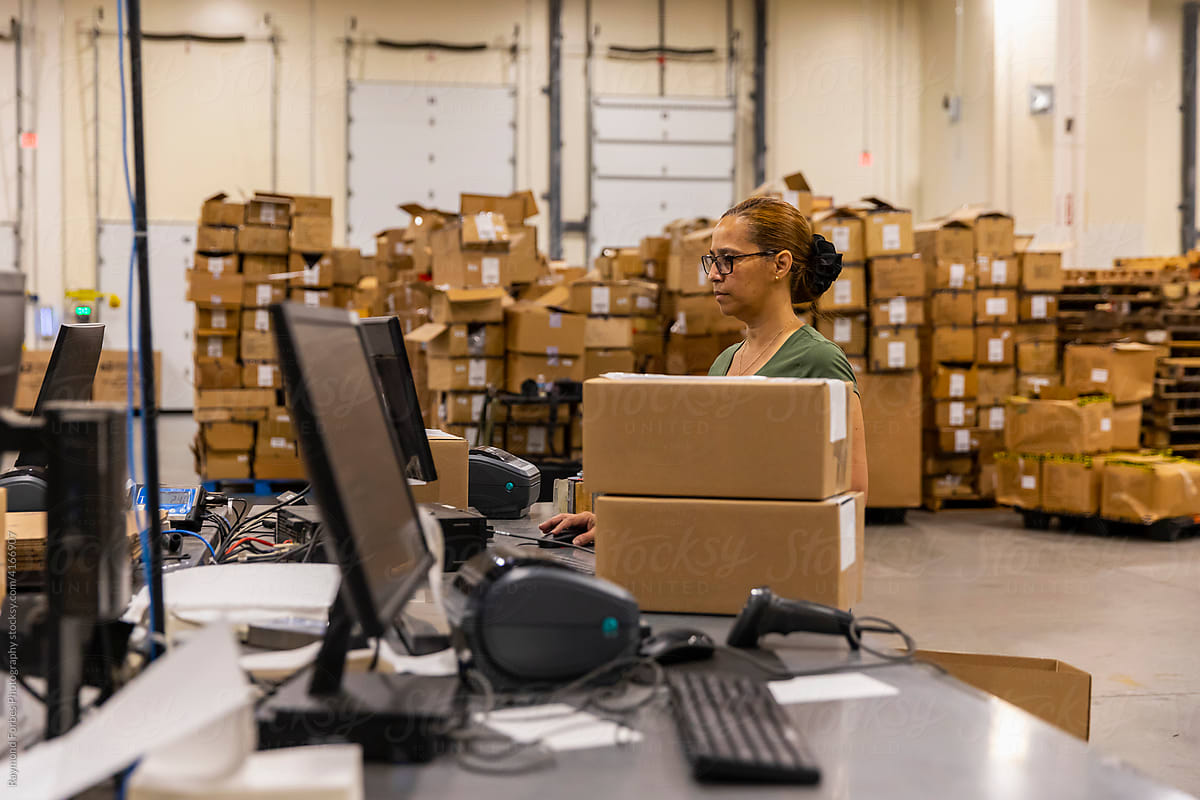 Worker at Shipping Station at warehouse for E-Commerce