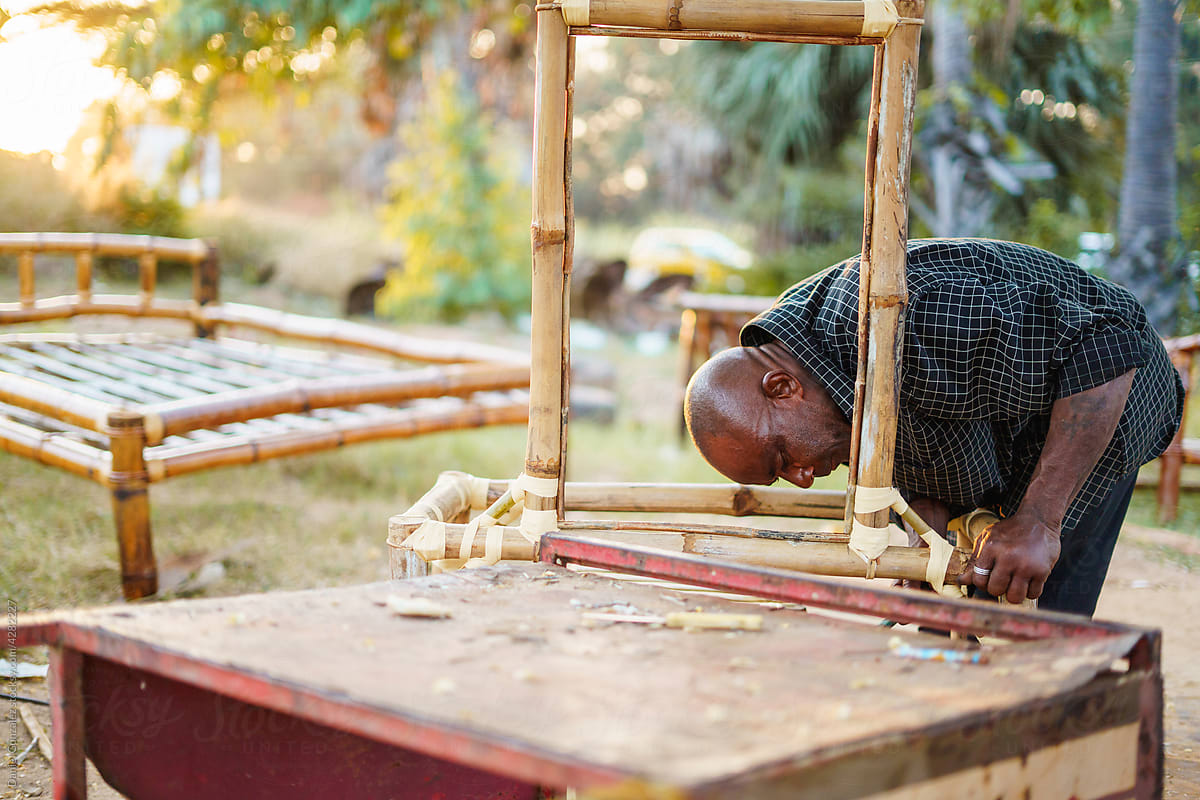 Man making bamboo furniture in countryside