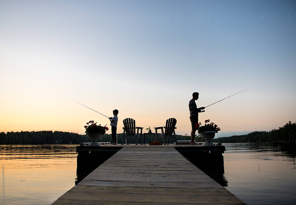 Father And Son In Silhouette Fish On A Dock Together by Stocksy Contributor  Cara Dolan - Stocksy
